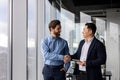 Professional businessmen shaking hands in office, colleagues and partners collaboration Royalty Free Stock Photo