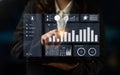 Professional businesswoman interacting with modern data visualization on laptop screen, displaying charts, graphs Royalty Free Stock Photo