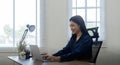 Professional businesswoman working at her home via laptop, young female manager using computer laptop while sitting on Royalty Free Stock Photo