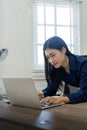 Professional businesswoman working at her home via laptop, young female manager using computer laptop while sitting on Royalty Free Stock Photo