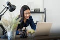 Professional businesswoman working at her home via laptop, young female manager using computer laptop while sitting on Royalty Free Stock Photo