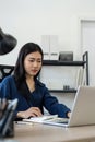 Professional businesswoman working at her home via laptop, young female manager using computer laptop while sitting on Royalty Free Stock Photo