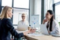 professional businesswomen smiling each other while working together Royalty Free Stock Photo