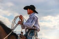 Professional Calf Roper wearing a wrangler shirt and cowboy hat