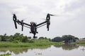 Professional camera drone flying on river and sky. Royalty Free Stock Photo