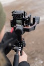 Professional camera mounted on a gimbal stabilizer being handled by an video operator Royalty Free Stock Photo