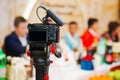 A professional camera on a tripod shoots a video of a Korean holiday.