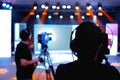 Professional cameraman - covering on event with a video, cameraman silhouette on live studio news, Selective focus Royalty Free Stock Photo