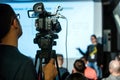 Professional cameraman with video camera on business conference Royalty Free Stock Photo