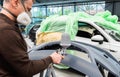 Professional car varnisher at work in a service station - Serie car repair workshop Royalty Free Stock Photo