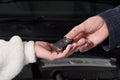 Mechanic giving car keys to customer after servicing Royalty Free Stock Photo