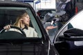 Mechanic giving car keys to female customer after servicing Royalty Free Stock Photo