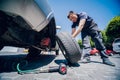 Professional car mechanic replace tire on wheel.