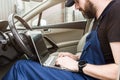 Professional car mechanic working in auto repair service. Computer video investigate. Engine diagnostics. Service Royalty Free Stock Photo