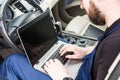 Professional car mechanic working in auto repair service. Computer video investigate. Engine diagnostics. Service Royalty Free Stock Photo