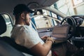 Car mechanic working in auto repair service using laptop Royalty Free Stock Photo