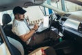 Car mechanic working in auto repair service using laptop Royalty Free Stock Photo