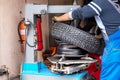 Professional car mechanical in workshop which replaces tires.