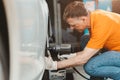 Professional car tire service man worker at automobile service center, male in auto mechanic work in garage car technician service Royalty Free Stock Photo