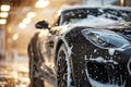 Professional Car Wash black Sportscar with Shampoo close-up Royalty Free Stock Photo
