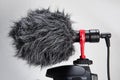 Professional Cardioid Directional Condenser Video Microphone black color attach on DSRL camera isolated on white
