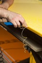 A professional carpenter handles the plastic edges of the countertop. The concept of furniture production