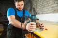 Professional carpenter processes the plastic edges of the countertop. The concept of furniture production Royalty Free Stock Photo