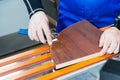 A professional carpenter processes the plastic edges of the countertop with a knife-edge cut. The concept of furniture Royalty Free Stock Photo