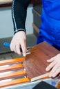 A professional carpenter processes the plastic edges of the countertop with a knife-edge cut. The concept of furniture Royalty Free Stock Photo
