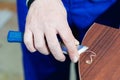 A professional carpenter processes the plastic edges of the countertop with a knife-edge cut. The concept of furniture Royalty Free Stock Photo