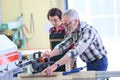 Professional carpenter teaching young woman apprentice Royalty Free Stock Photo