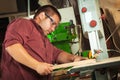 Professional carpenter working with sawing machine. Royalty Free Stock Photo