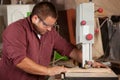 Professional carpenter working with sawing machine. Royalty Free Stock Photo