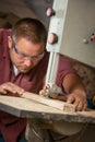 Professional carpenter working with sawing machine. Royalty Free Stock Photo