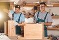 Professional carpenters assembling cabinet in workshop Royalty Free Stock Photo