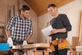 Professional carpenters working with draft
