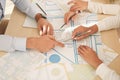 Professional cartographers working with cadastral map at table, closeup