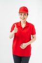Professional caucasian female in cap, t-shirt, jeans working as courier or dealer, showing thumbs up gesture