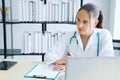 Professional Caucasian Female Psychiatrist MD is Studying and researching on website with laptop for treament patient . Royalty Free Stock Photo