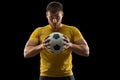 Professional caucasian football soccer player standing isolated on black studio background.