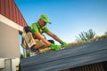 Professional Caucasian Gardener Building Living Roof on a Garden Shed Royalty Free Stock Photo