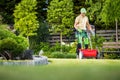 Professional Gardener with Lawn and Garden Seed Spreader