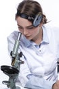 Professional Caucasian Laboratory Researcher in Smock Working With Microscope While Conducting a Research and Making Notes Royalty Free Stock Photo