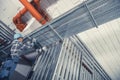 Technician Installing Electric Lines Along Aluminium Elements in a Commercial Building