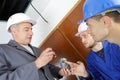 Professional cctv technician working with apprentice