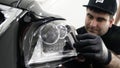 Professional ceramics handler apply different layers to the car using an applicator sponge, fiber immediately checking the effec