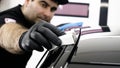 Professional ceramics handler apply different layers to the car using an applicator sponge, fiber immediately checking the effec