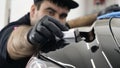 Professional ceramics handler apply different layers to the car using an applicator sponge, fiber immediately checking the effec