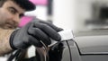 Professional ceramics handler apply different layers to the car using an applicator sponge, fiber immediately checking the effec