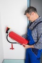 Professional Checking A Fire Extinguisher Royalty Free Stock Photo